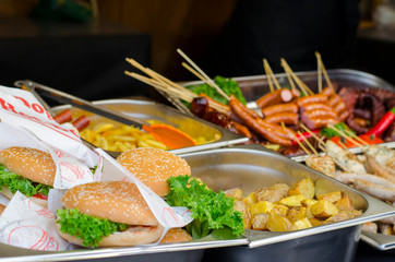 grilled street food on the christmas fair, including burgers, fries, and sausages. Lviv, Ukraine