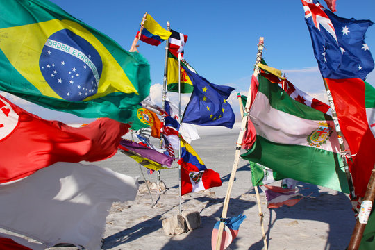 Flags in a salt desert of Salar de Uyuni in Bolivia.
