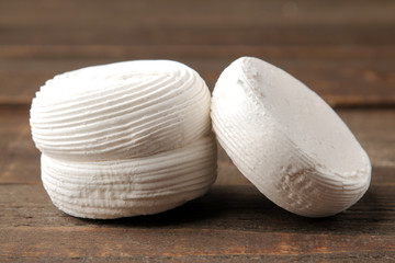 Sweet white marshmallow on a brown wooden table. Sweets. close-up