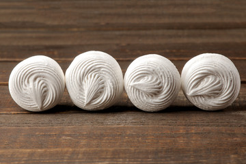 Sweet white round marshmallow on a brown wooden table. Sweets. dessert.