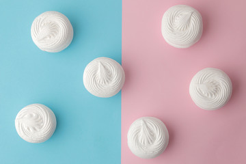 background of sweet white round marshmallows on bright trendy pink and blue background. Sweets. dessert. view from above