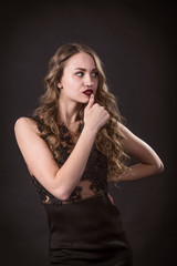 Naklejka premium Portrait of a young girl in lace dress on a black background
