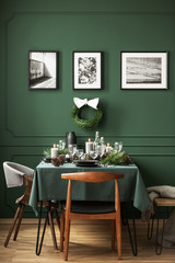 Bottle green dining room with table set for Christmas dinner