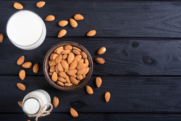 Obraz na płótnie Canvas Almond milk on wooden table