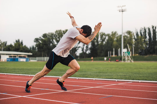 Athlete running on tartan track