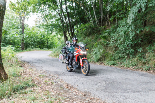 Father and son on a motorbike trip on a country road