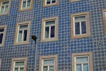 The old facade of the building is covered with azulejo ceramic t