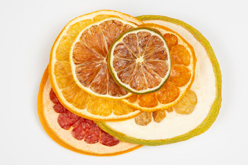 Dried slices of various citrus fruits on white background