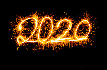 Happy New Year 2020 golden numbers written with Sparkle fireworks isolated on black background