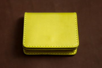 wallet yellow on a brown background