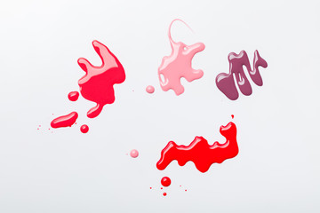 top view of spills with shiny nail polish isolated on grey