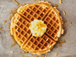 rustic traditional waffle with butter and maple syrup