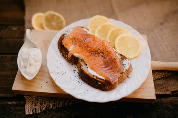 Smoked salmon with cheese toasted bread lemon and yogurt dip