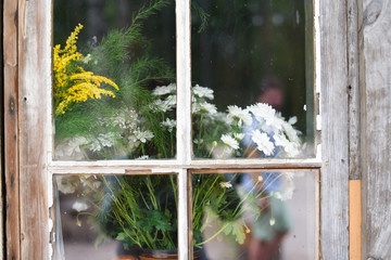 Flowers behind the glass window
