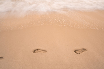 sea wave move to erase human footprint on beach