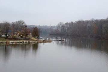A view of the lake on a cloudy misty foggy morning.