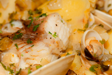 Detail of a monkfish dish with clams