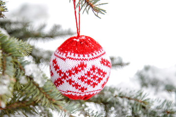 Closeup of red bauble hanging from a decorated Christmas. Merry Christmas and Happy New Year  tree