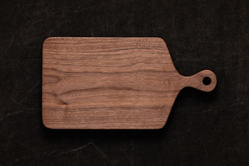 Handmade walnut chopping board on handmade tie dyed burlap.