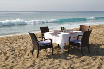 Table and chairs on the beach by the sea. Romantic concept. Marine Cafe.