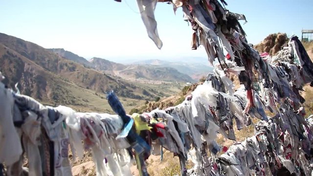 transfer focus from colourful rags on the rope to mountain valley, Chatkal Mountain(Greater Chimgan), Uzbekistan