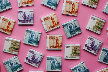 Fototapeta na wymiar Chocolate banknote 5000, 2000, 1000, 500 rubles on a colored background. Russian money. Nominal cost. Symbolic sweet food.