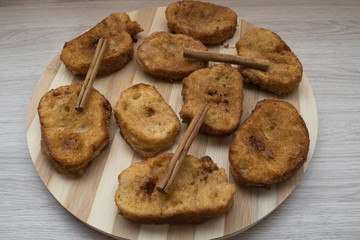Homemade Spanish milk torrijas with cinnamon sticks. Traditional Easter dessert