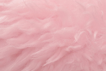 Pink animal wool texture background. Rosy tint natural wool. Close-up texture of  plush fluffy fur