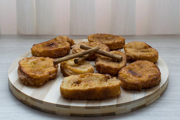 Homemade Spanish milk torrijas with cinnamon sticks. Traditional Easter dessert