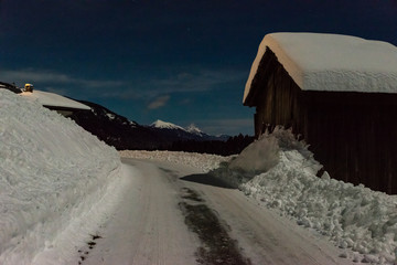 cabin in the alps covered with snow at night