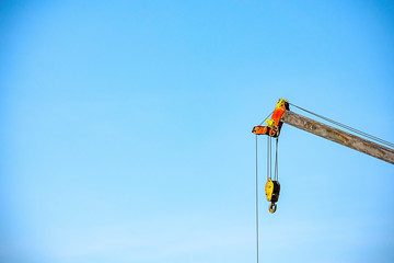 Sling and hoist the crane arm The background sky