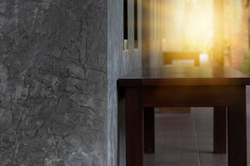 Wooden stools along the lime wall have light from the passage.