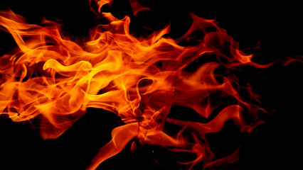 Fototapeta premium Fire flames on Abstract black background, Burning red hot sparks rise from large fire in, Fiery orange glowing