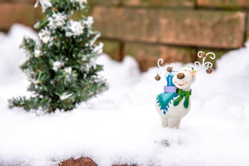 christmas holiday decorations a Christmas tree outside winter snow deer