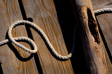 sailor rope and knot on a wooden pier at the seaside