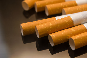 scattered cigarettes on the black glass table