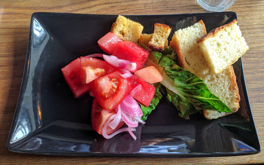 Bread and Vegetables on a black plate