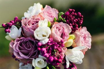 Close-up of a wedding bouquet of roses and lilacs in white viole