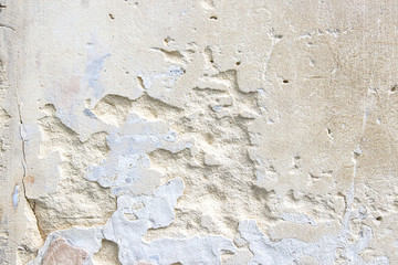 Light sandstone wall with different irregularities.