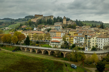 Fototapeta premium Aerial panorama view of Castrocaro di Terme, famous Italian thermal spa town in Cesena-Forli province, Emilia Romagna, near Terra del Sole, home to a Medici fortress castle in ruins a famous bridge