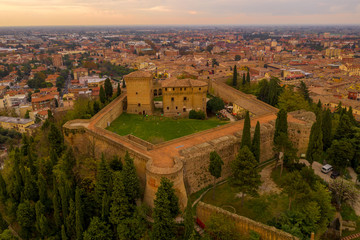Fototapeta na wymiar Sunset aerial panorama of Cesena in Emilia Romagna Italy near Forli and Rimini, with the medieval Malatestiana castle, Piazza del Popolo and Roman Catholic churches and cathedral on a winter afternoon