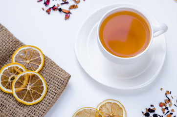 Orange herbal flavored christmas tea with cinnamon and cardamom honey white cup on a white wooden table