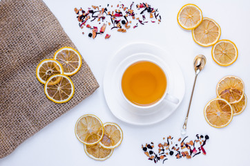 Obraz na płótnie Canvas Orange herbal flavored christmas tea with cinnamon and cardamom honey white cup on a white wooden table
