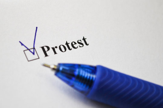 Protest checkbox on white paper with black ink pen. Checklist concept. Questionnaire, survey. Checked box with inscription. Selective focus