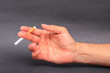 Man holding cigarette between fingers