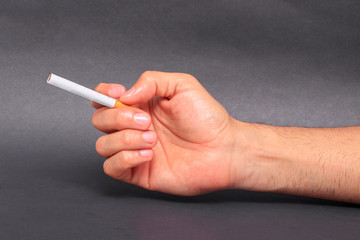 Man holding cigarette between fingers