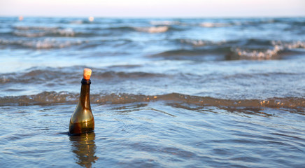 bottle with a treasure map floating in the sea