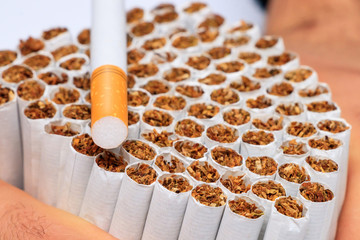 Woman is holding a cigarette in her hand