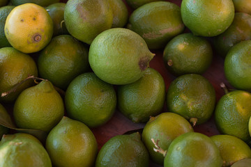 soft focus lemon green fruits on market counter background