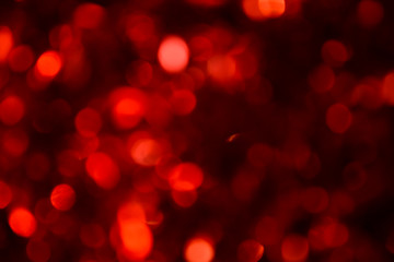 Bokeh. Holiday background. Christmas lights. Glitter. Defocused sparkles. New Year backdrop. Festive wallpaper. Blinks. Carnival. Bokeh retro style photo. Red.